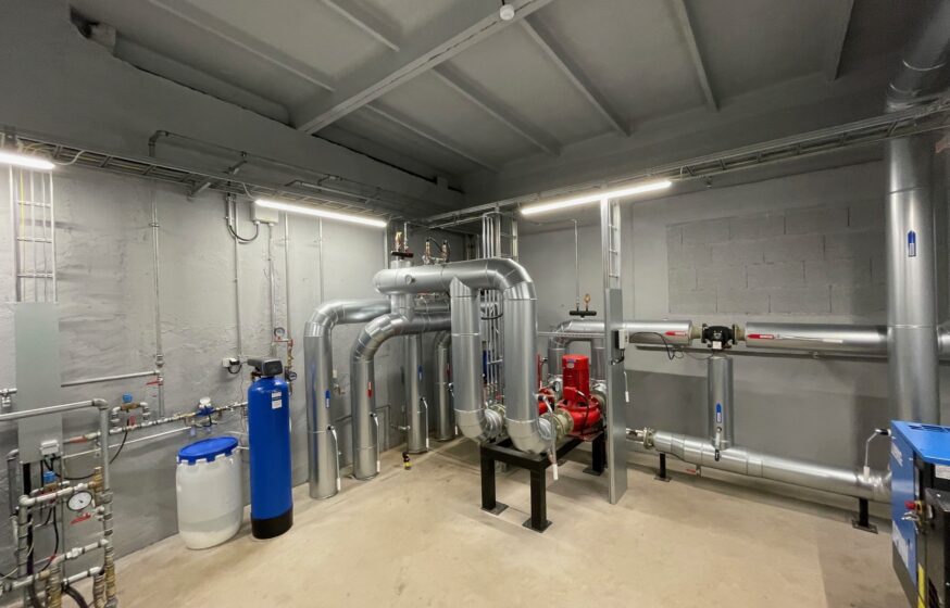 District heating substation with insulated pipes, circulation pumps and heat distribution equipment