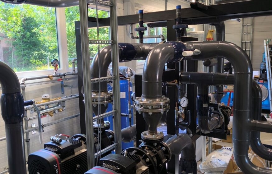 Mechanical piping skid with pumps and heat exchanger installed inside an biomass boiler plant