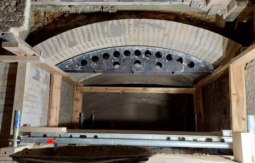 Refractory masonry works showing cast arch preparation in an industrial furnace